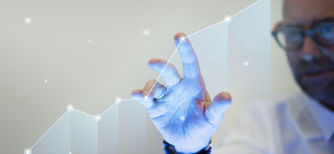 Businessman pointing his finger to a growth graph