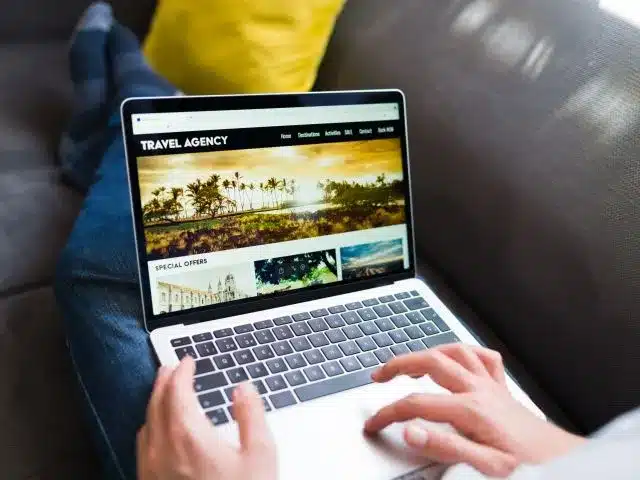 online-travel-agency-young-person-booking-vacations-holiday-laptop-scaled-thegem-blog-justified